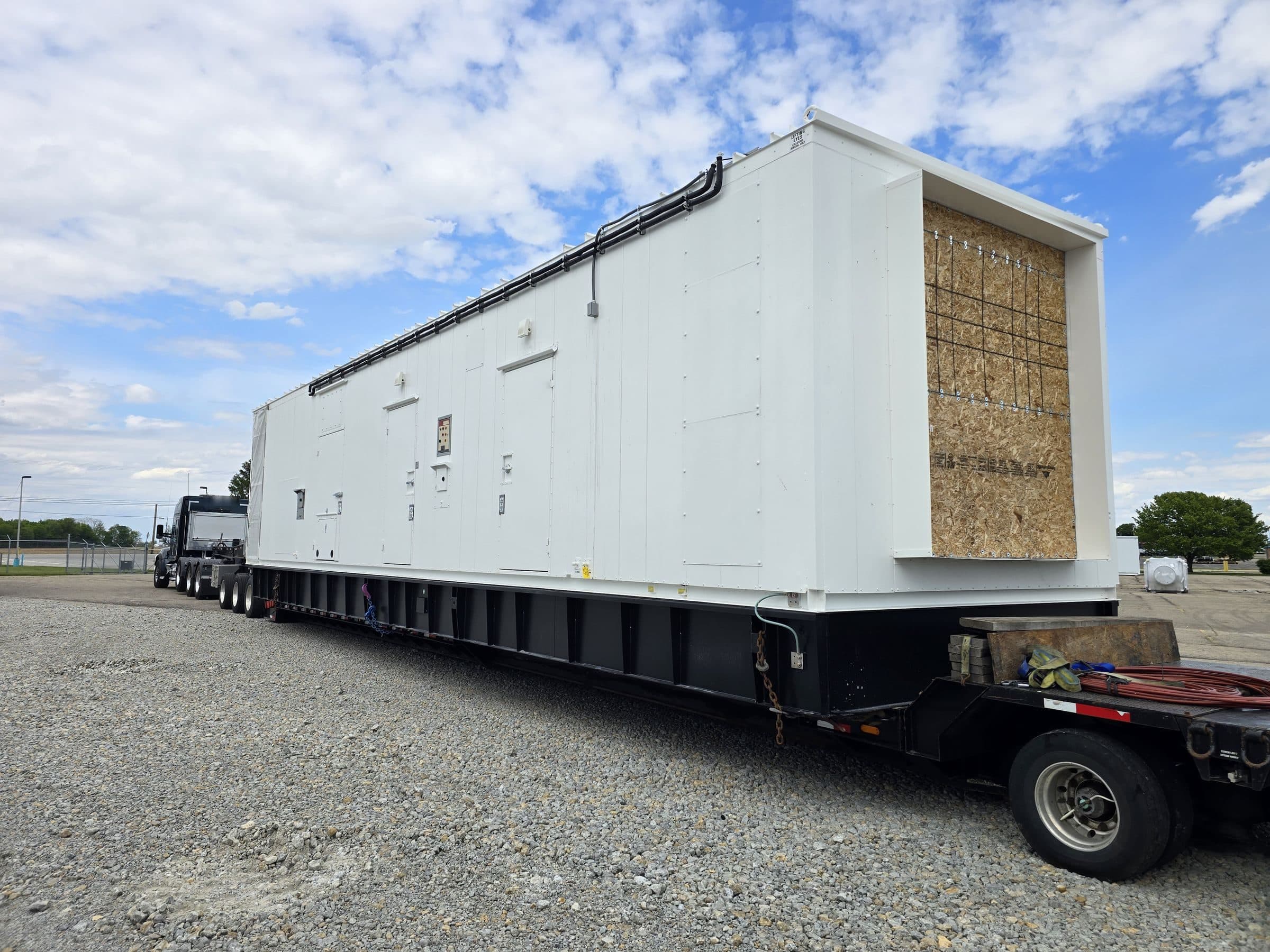 White power-generation enclosure loaded on the extended main deck