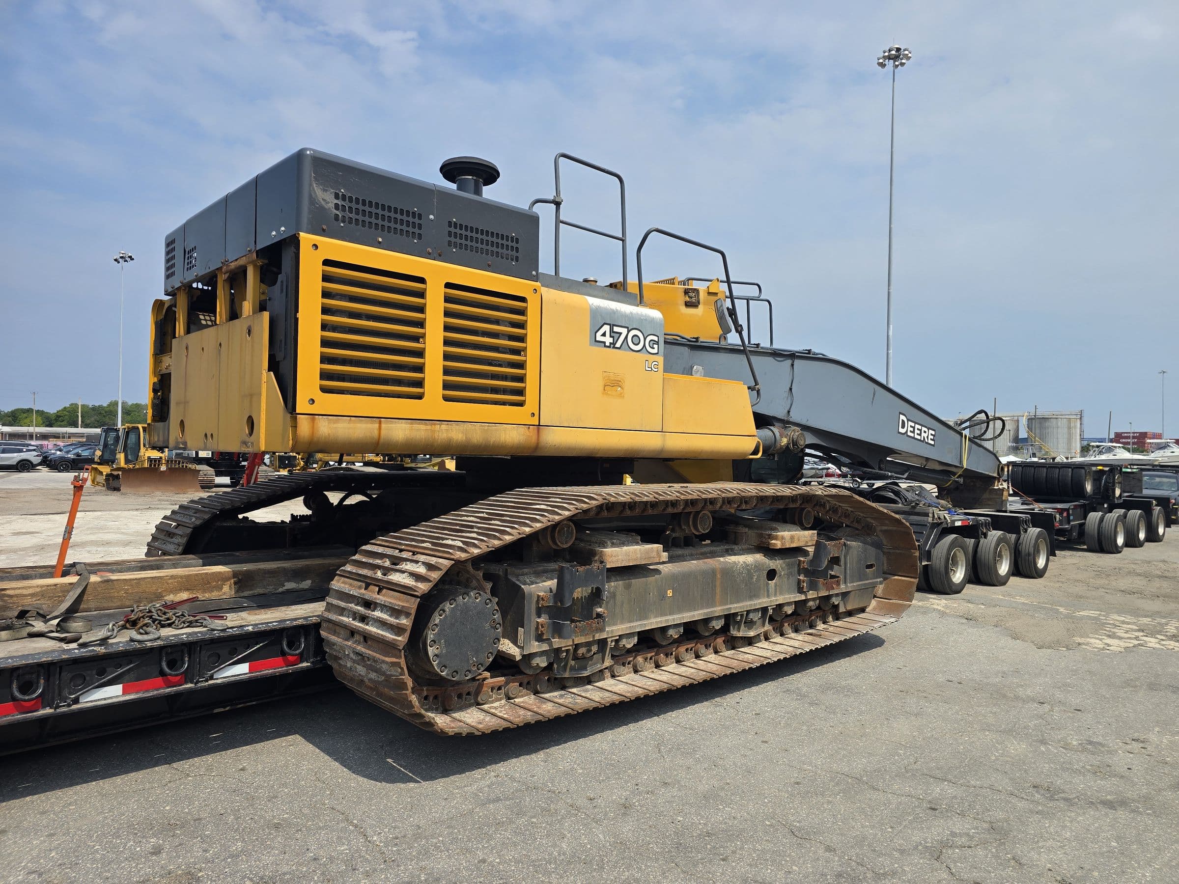 John Deere 470G excavator chained down on the lowboy deck